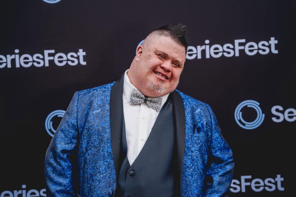 José smiling in a blue patterned tuxedo jacket and silver bow tie at SeriesFest.