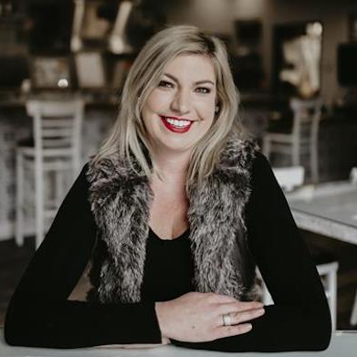 Tiffany Fixter, founder of Brewability, seated inside a restaurant.