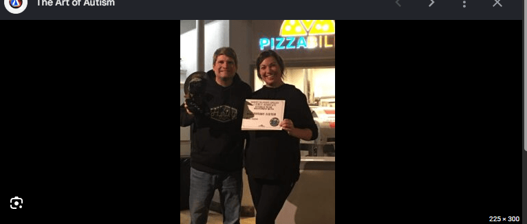 Tiffany Fixter and another person holding an award certificate together at Pizzability.